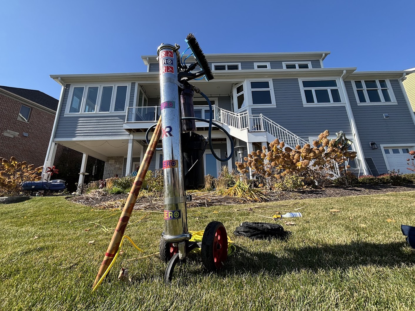 Professional window cleaner safely applying specialized treatment